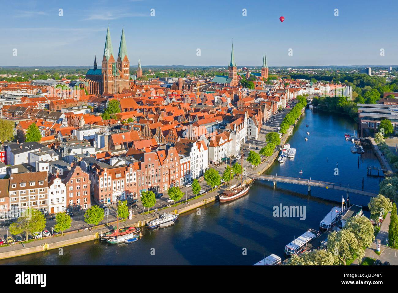 Aerial view over the river Trave and old sailing ships and boats in the old town of the Hanseatic City of Lübeck, Schleswig-Holstein, Germany Stock Photo