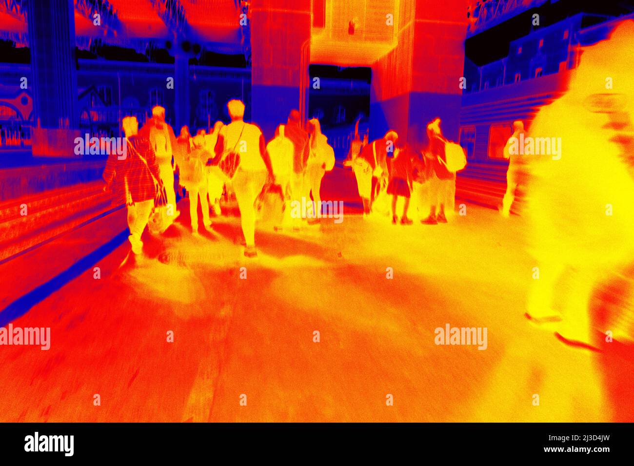 Railway station. Commuter train and passengers on the boarding platform, trainshed. Illustration of thermal image - thermal impressionism. Stock Photo