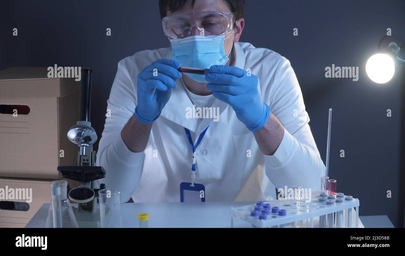 Doctor holding Coronavirus 2019-nCoV blood sample. Concept of vaccination, Covid 19 diagnostic. Diagnosis and laboratory. Scientist with positive Stock Photo