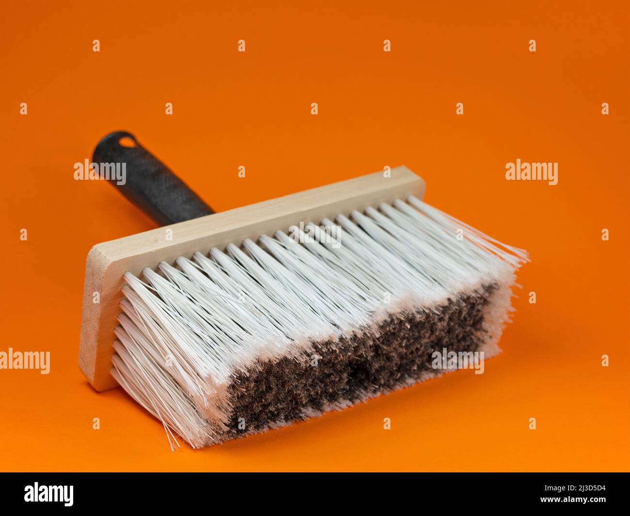 Wide brush against an orange background Stock Photo