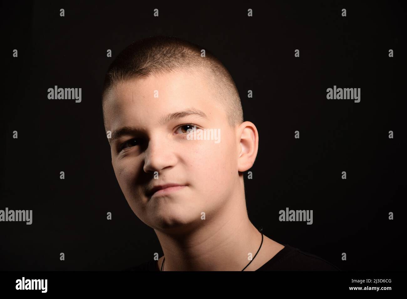 Young caucasian guy with a short haircut on a black clipping background Stock Photo