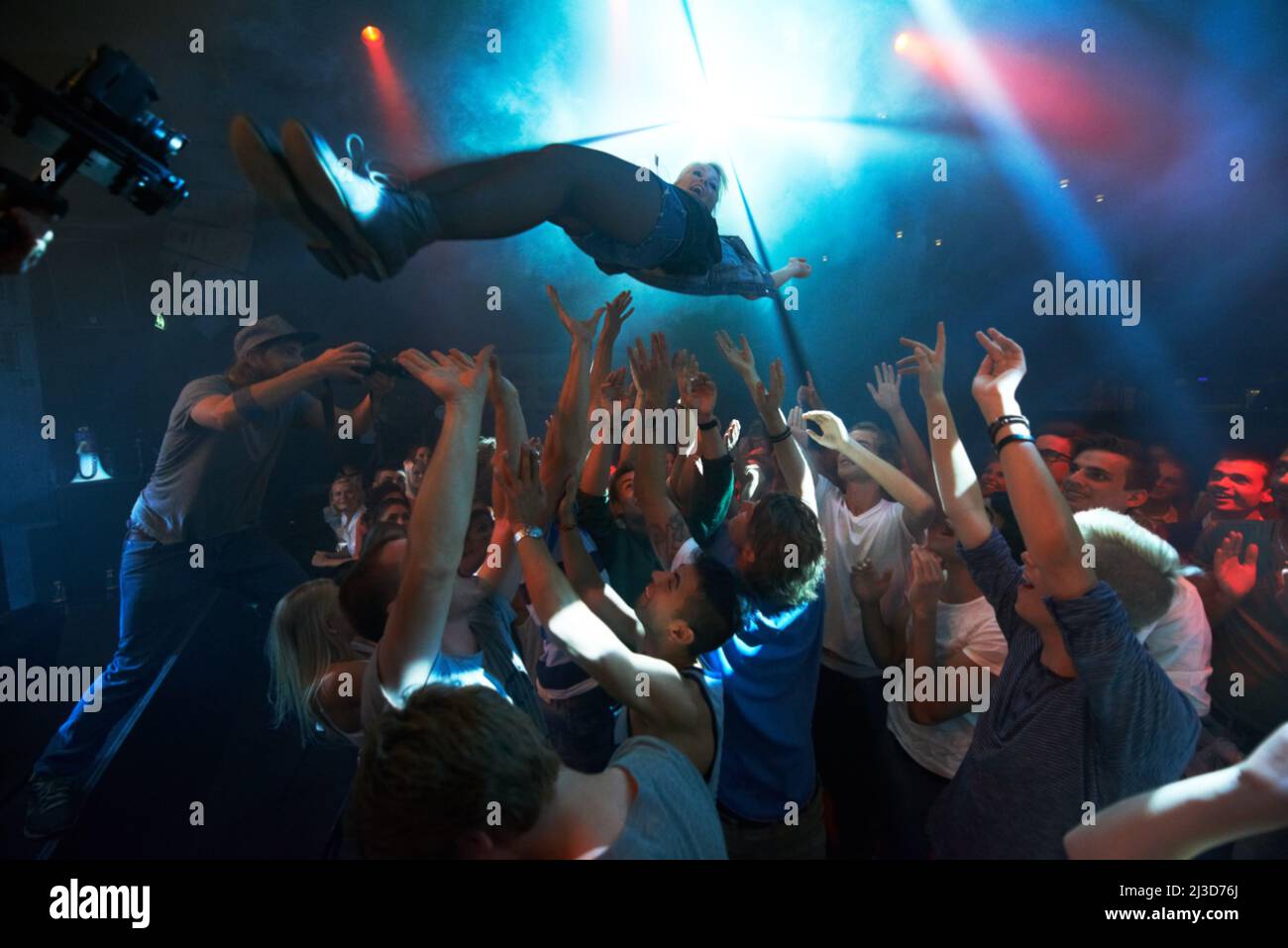 Falling into the crowd. A band playing on stage at a concert- This concert was created for the sole purpose of this photo shoot, featuring 300 models Stock Photo
