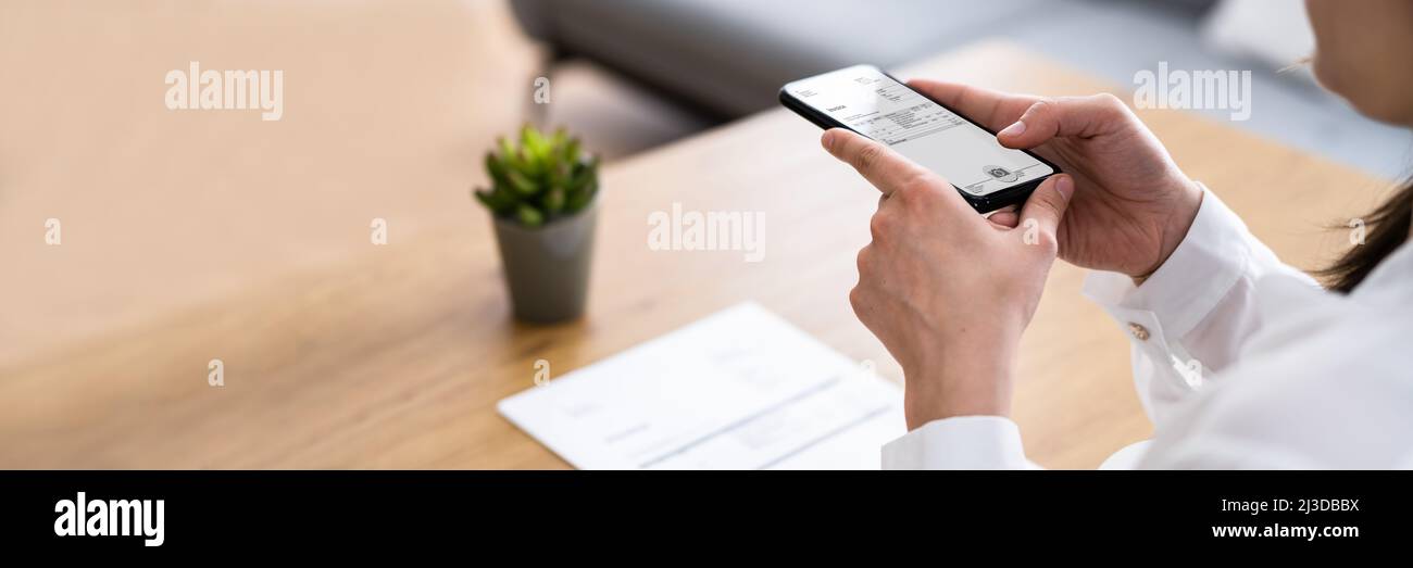 Taking Invoice Document Photo Using Phone Or Smartphone Stock Photo