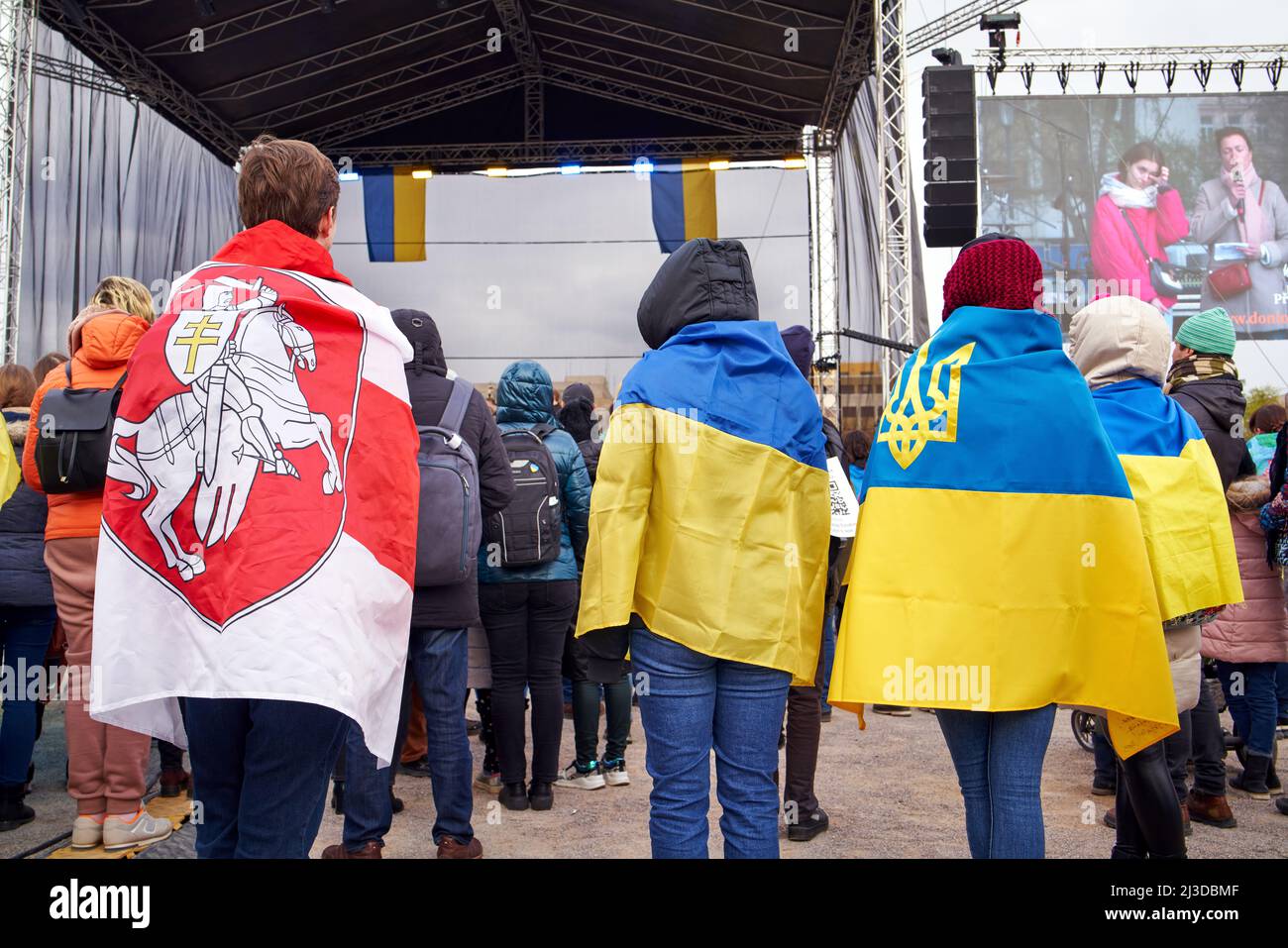 PRAGUE, CZECH REPUBLIC - APRIL 3, 2022: People dressed in Ukrainian and Belarusian opposition flags at the Letna beneficial concert in support against Stock Photo