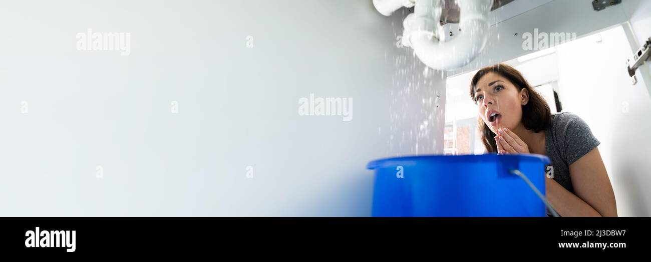 Woman With Emergency Plumbing Sink Leak Problem Stock Photo Alamy