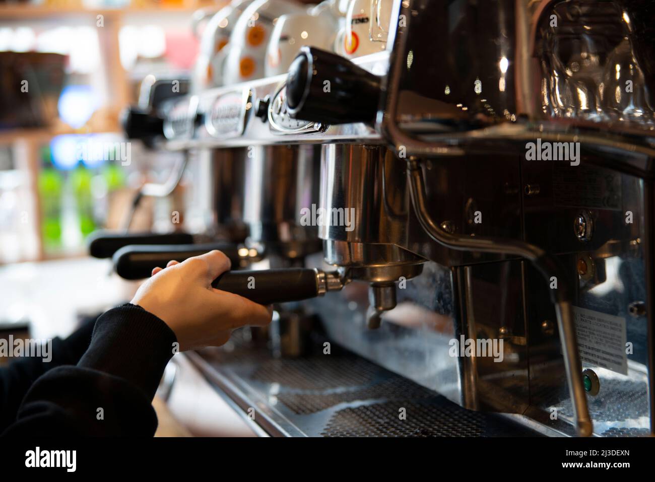 Barista making coffee at a coffee shop Stock Photo