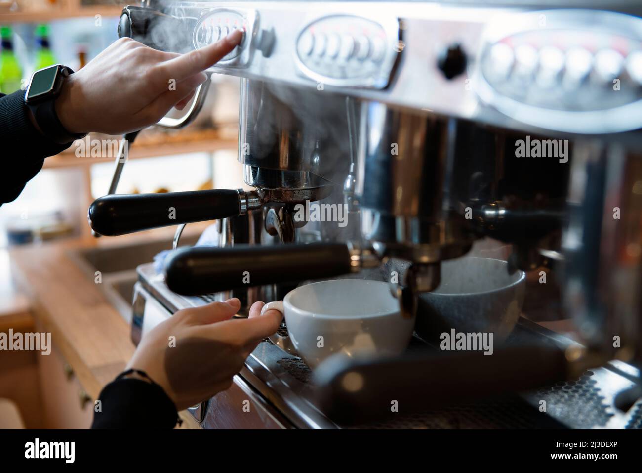 Barista making coffee at a coffee shop Stock Photo