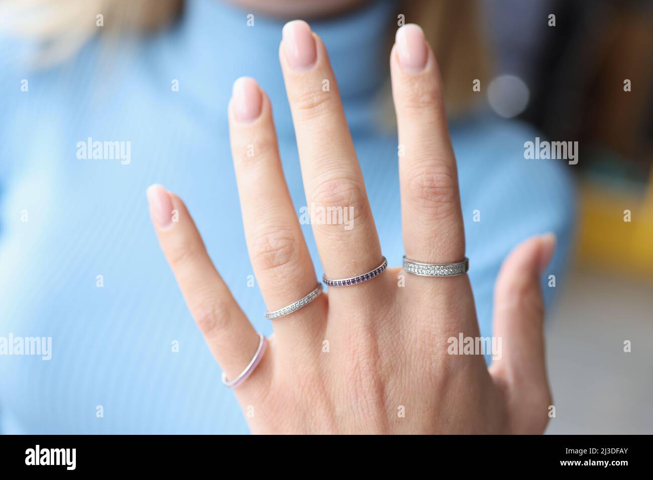 Woman hand with beautiful thin silver rings Stock Photo