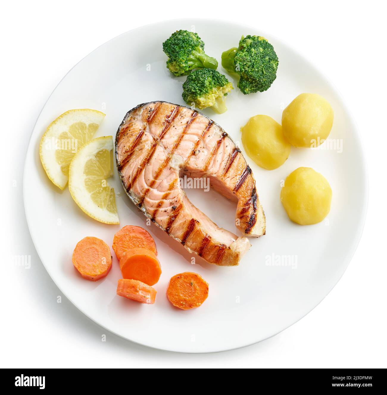 plate of grilled salmon steak and vegetables isolated on white ...