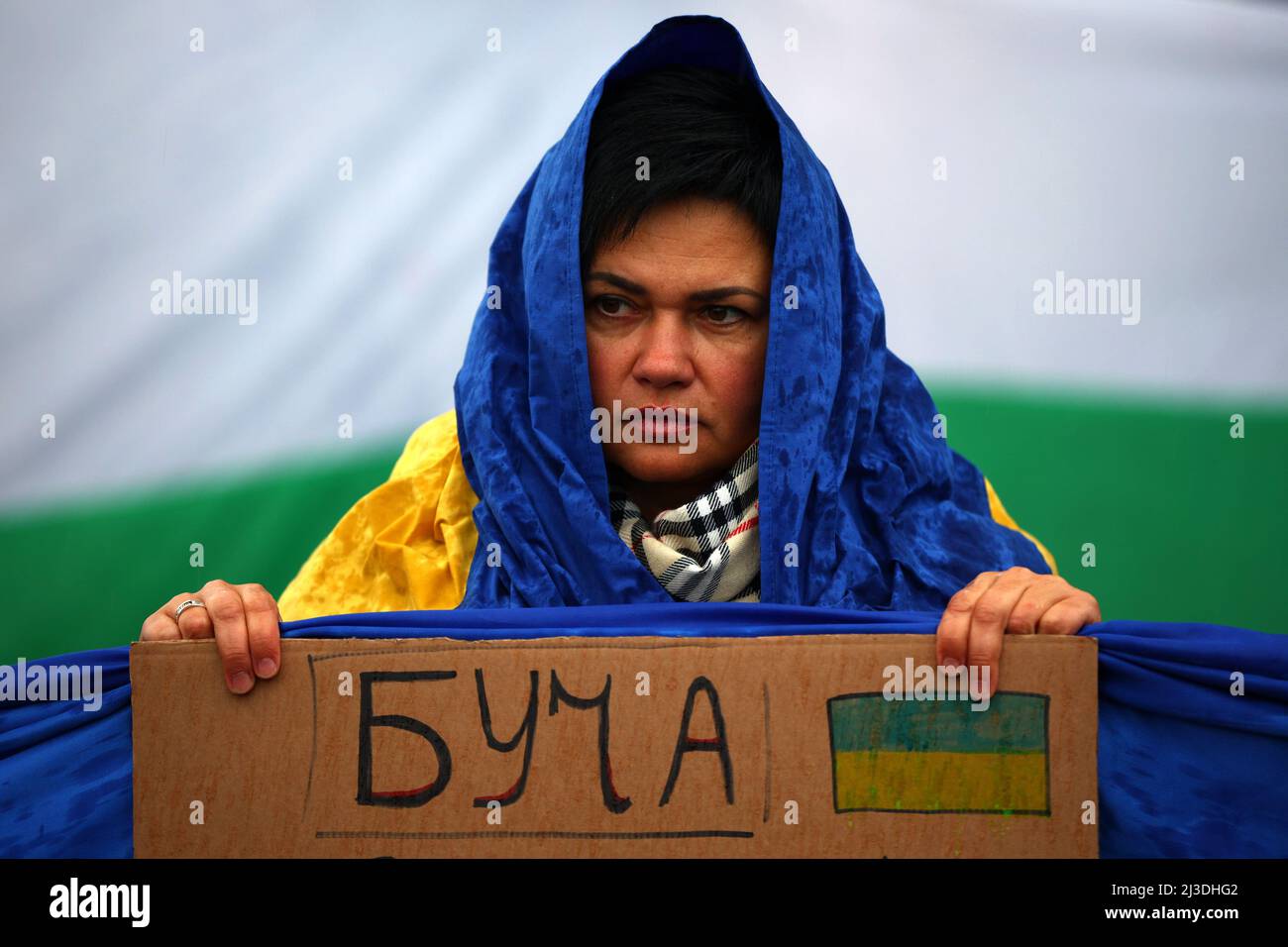 Sofia, Bulgaria - 7 April, 2022: Woman holds a sign with the name of Ukrainian city 'Bucha' during a demonstration in support of Ukraine. On 24th of February Russian army entered Ukrainian territory in what the Russian president Vladimir Putin declared a 'special military operation'. Stock Photo