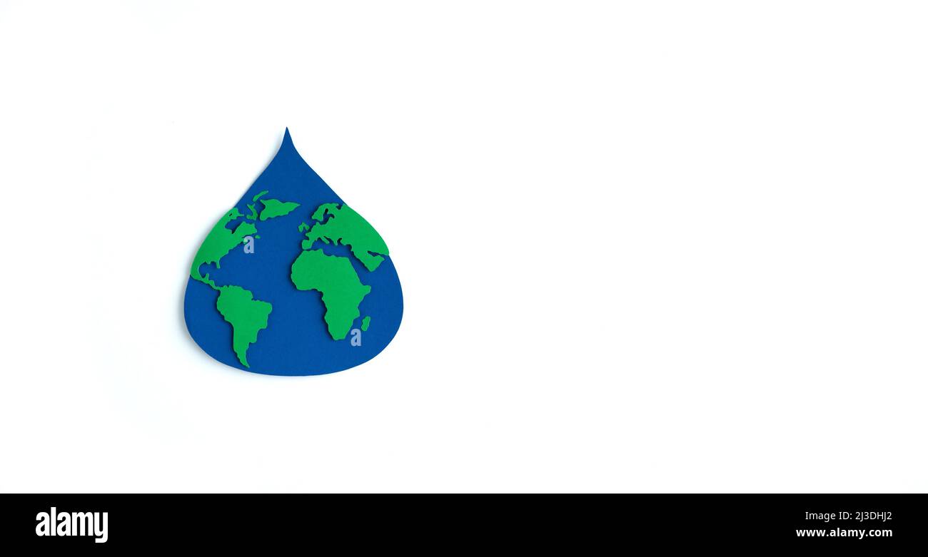 Paper cutout water drop with world map inside on white background. Copy space. Earth day. Top view. Stock Photo