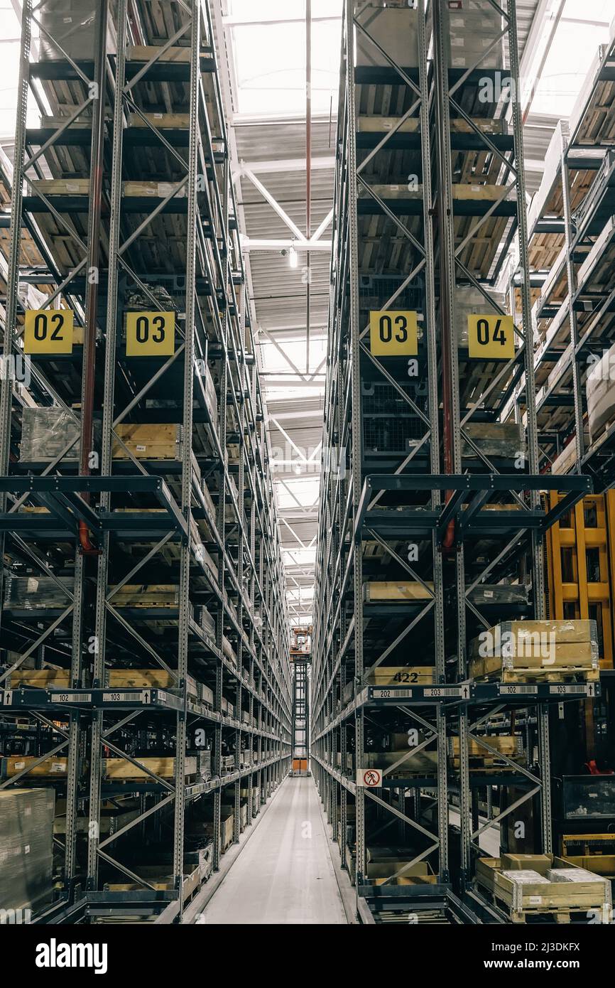 Warehouse of logistic company. Large distribution storehouse with high shelves. Stock Photo