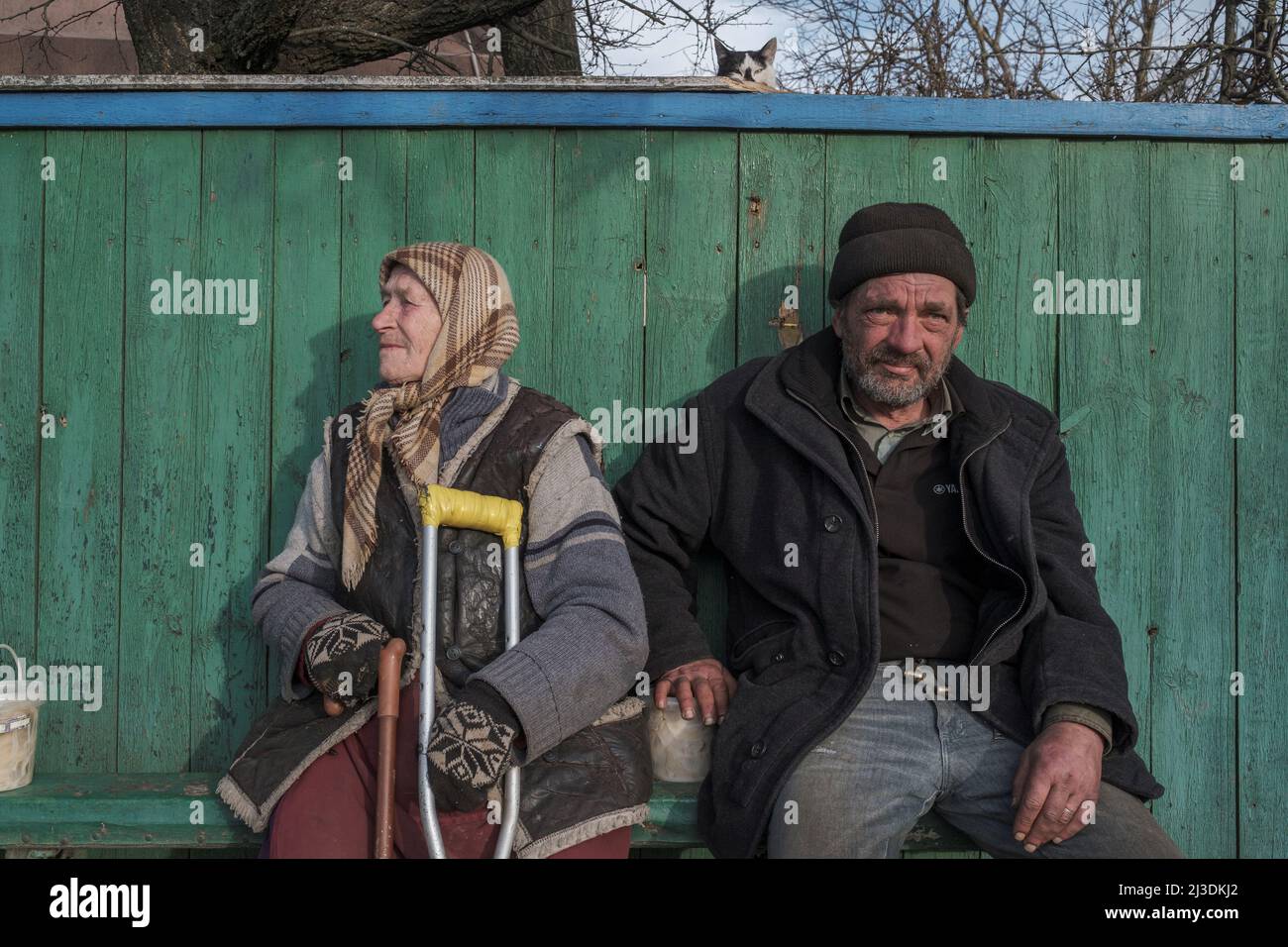 Locals sit in front of their house, amid Russia's invasion of Ukraine in the village of Andriivka, in the Kyiv region, Ukraine, April 7, 2022. REUTERS/Marko Djurica Stock Photo