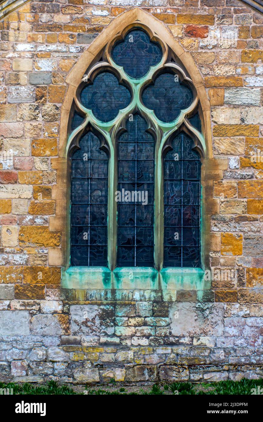 Detail of stonework and arched window at Tewkesbury Abbey in Gloucestershire England UK Stock Photo