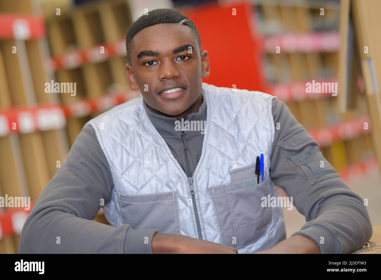 portrait of young male warehouse worker Stock Photo - Alamy