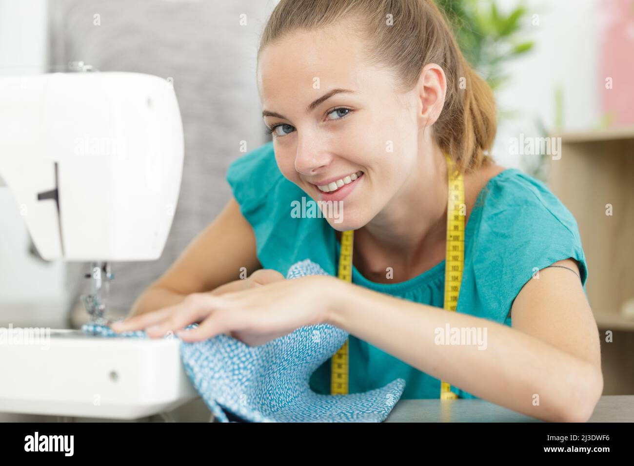 woman making clothes using sewing machine at home Stock Photo Alamy