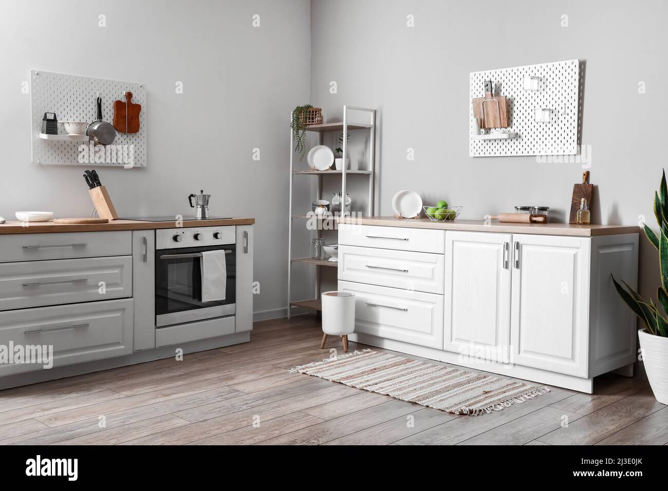 Interior of modern kitchen with shelving unit, pegboard and modern ...