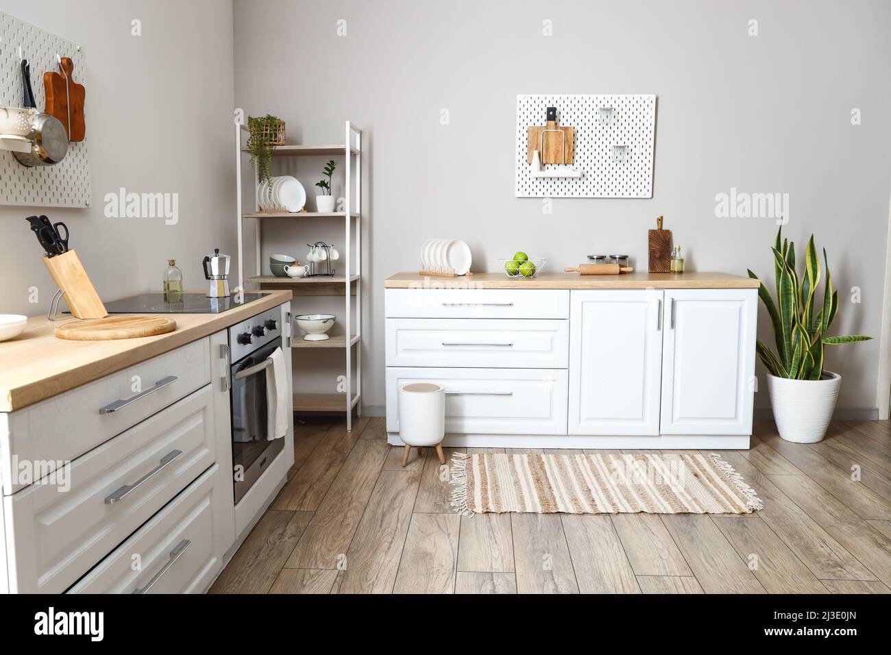 Interior of modern kitchen with shelving unit, pegboard and modern ...