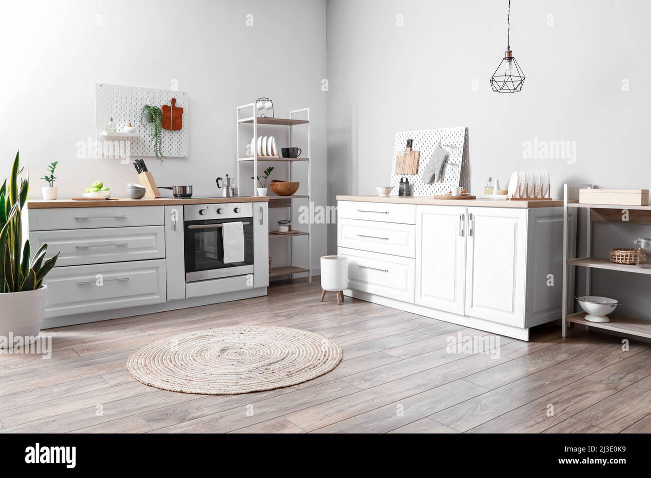 Interior of modern kitchen with shelving unit, pegboard, counters and ...