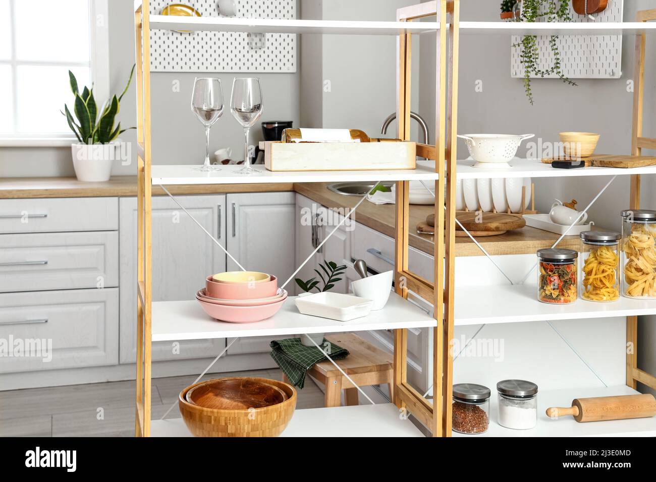 Modern shelving unit with dishware in kitchen Stock Photo Alamy