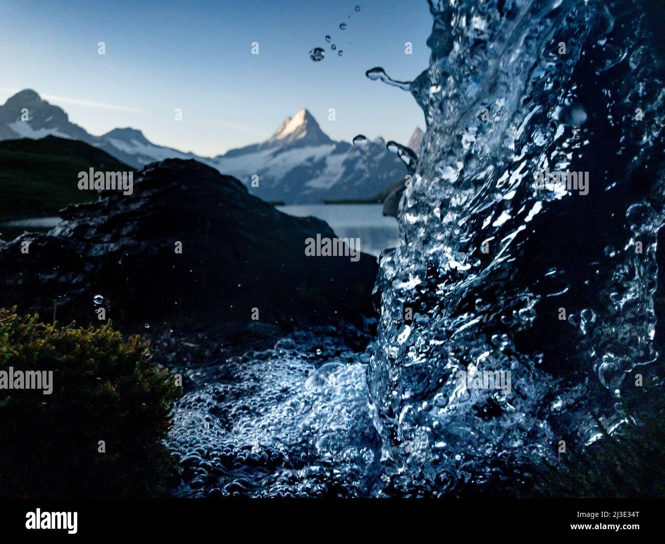 bubblying fresh water of an alpine creek in the swiss alps Stock Photo