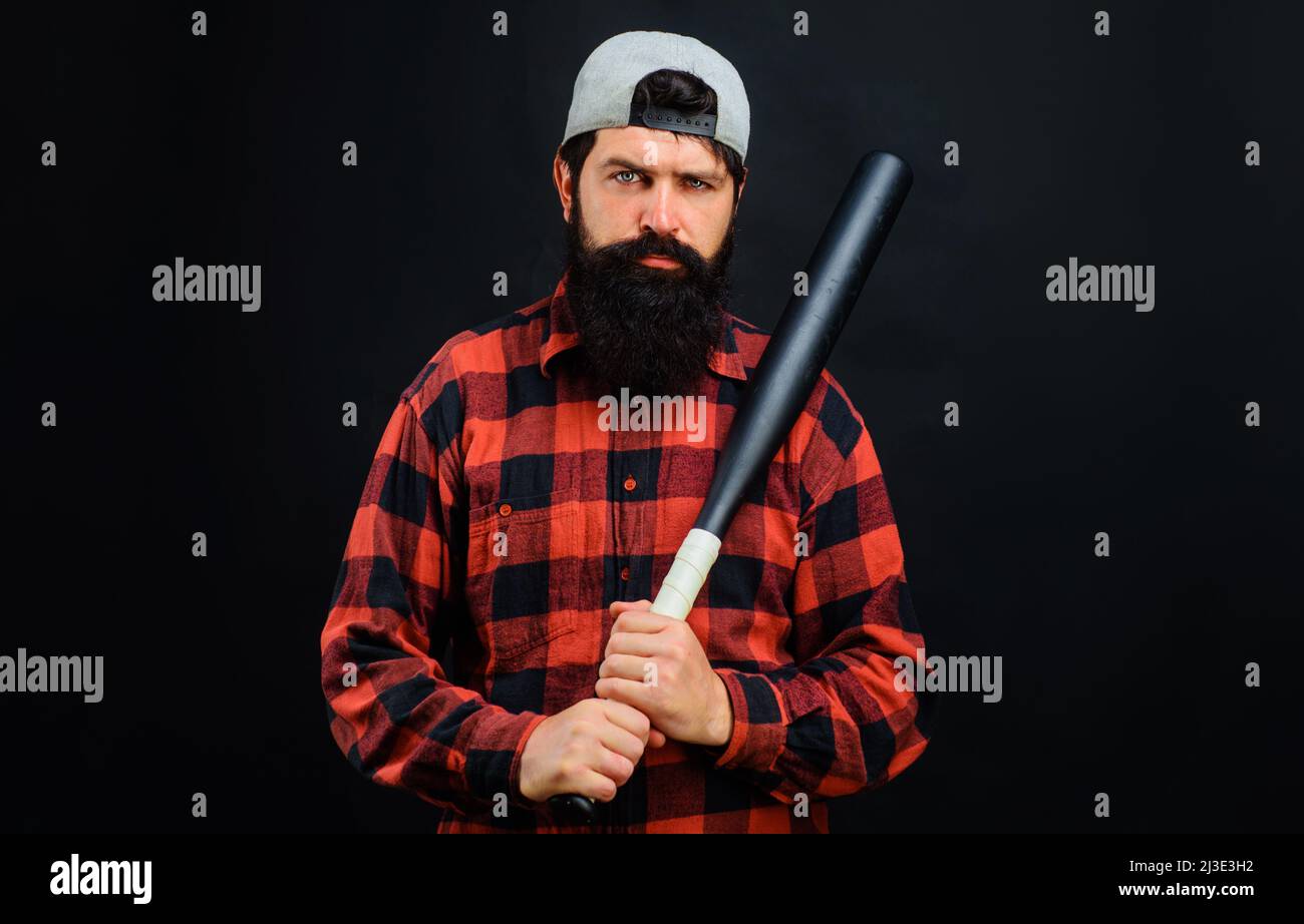 Bearded man with baseball bat. Sport, training, healthy lifestyle. Professional baseball player in cap. Stock Photo