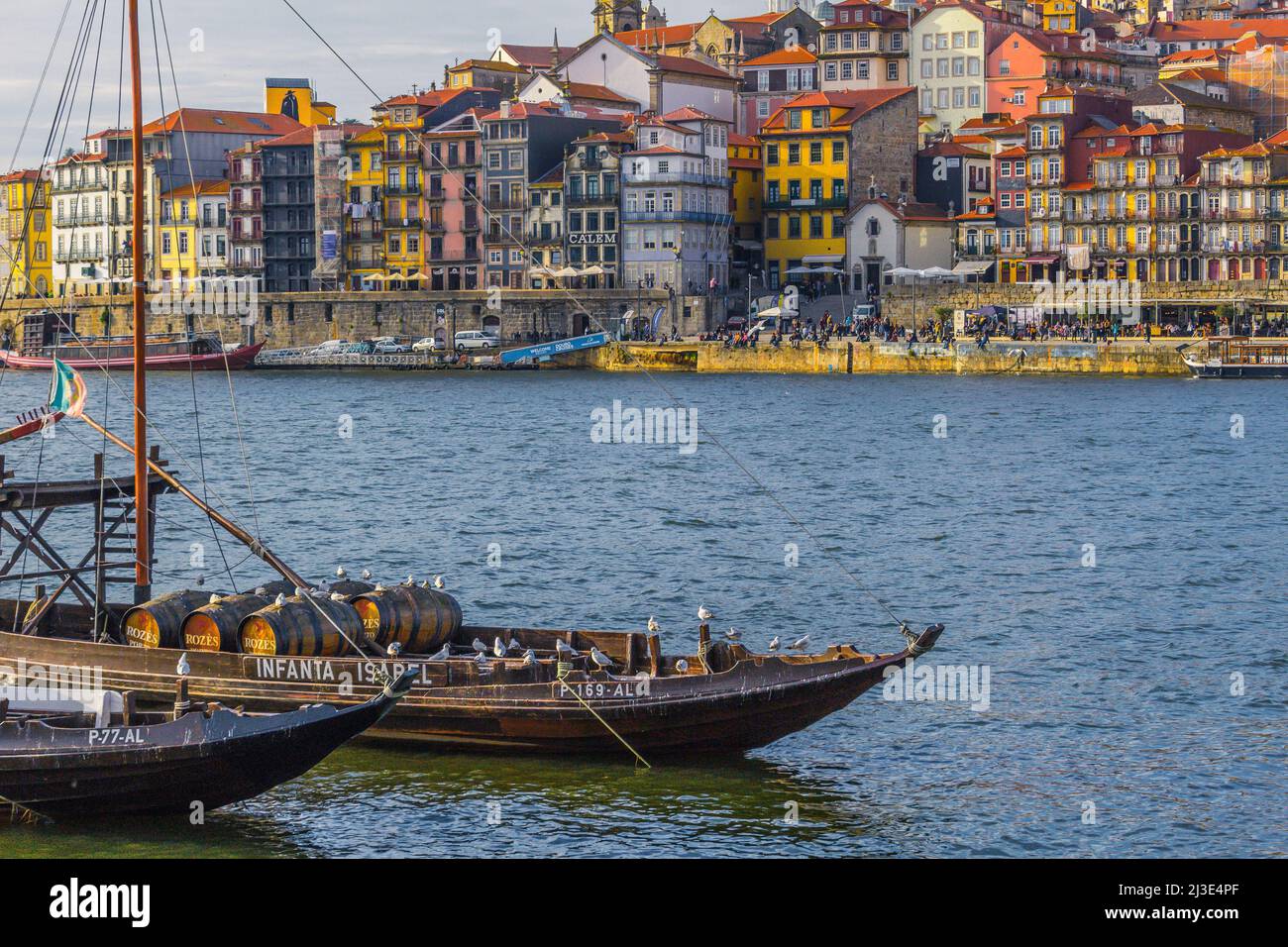 View of old town Porto from Vila Nova de Gaia with old port shipping boats in the foreground. Stock Photo