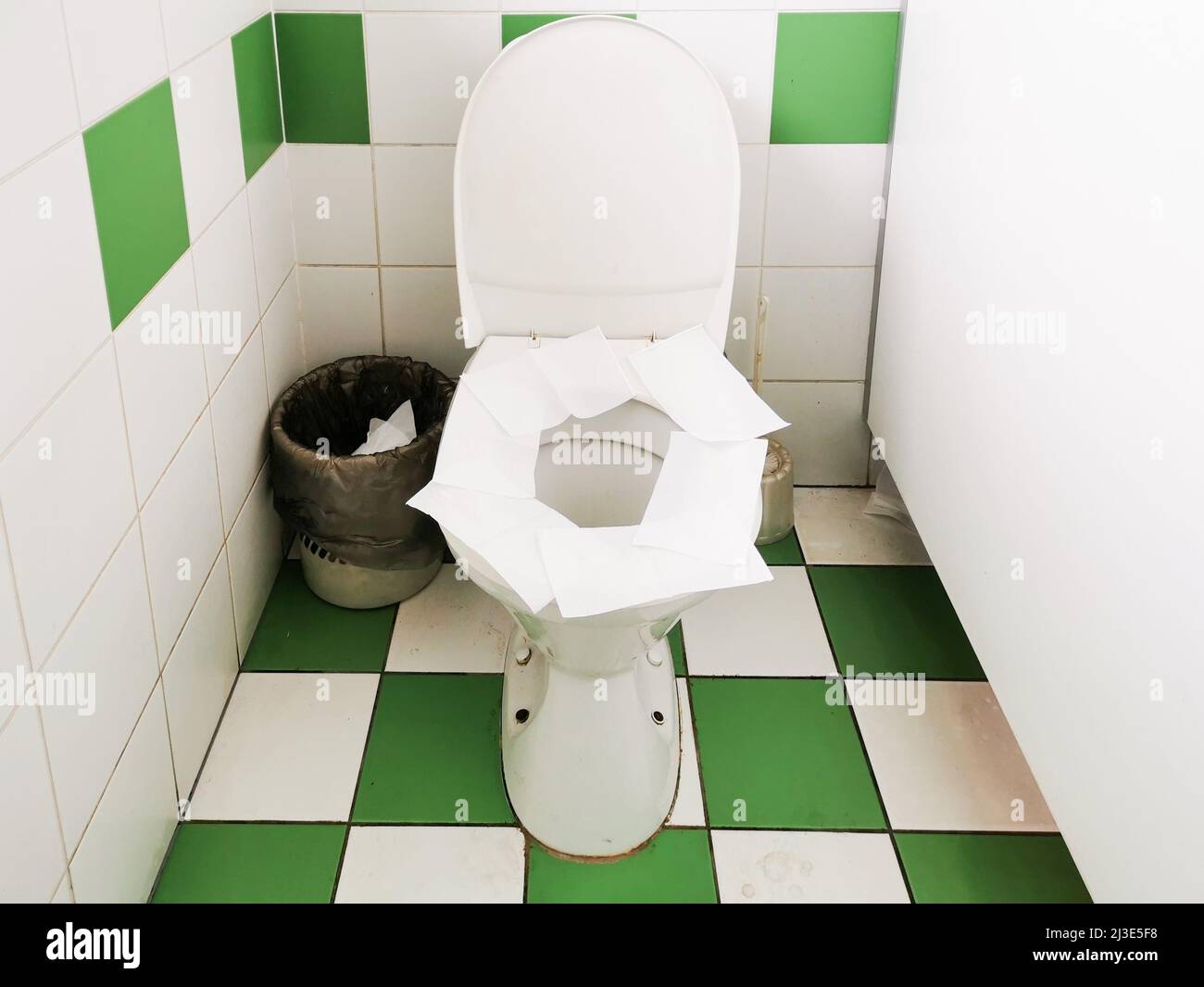 Toilet paper covers the toilet seat. Hygiene products in a public toilet Stock Photo Alamy