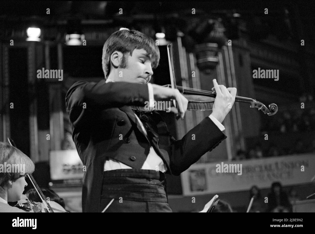 English violinist and violist Nigel Kennedy, aged 26, performing at one of the Schools Prom concerts, Royal Albert Hall, London, England in November 1982. Stock Photo