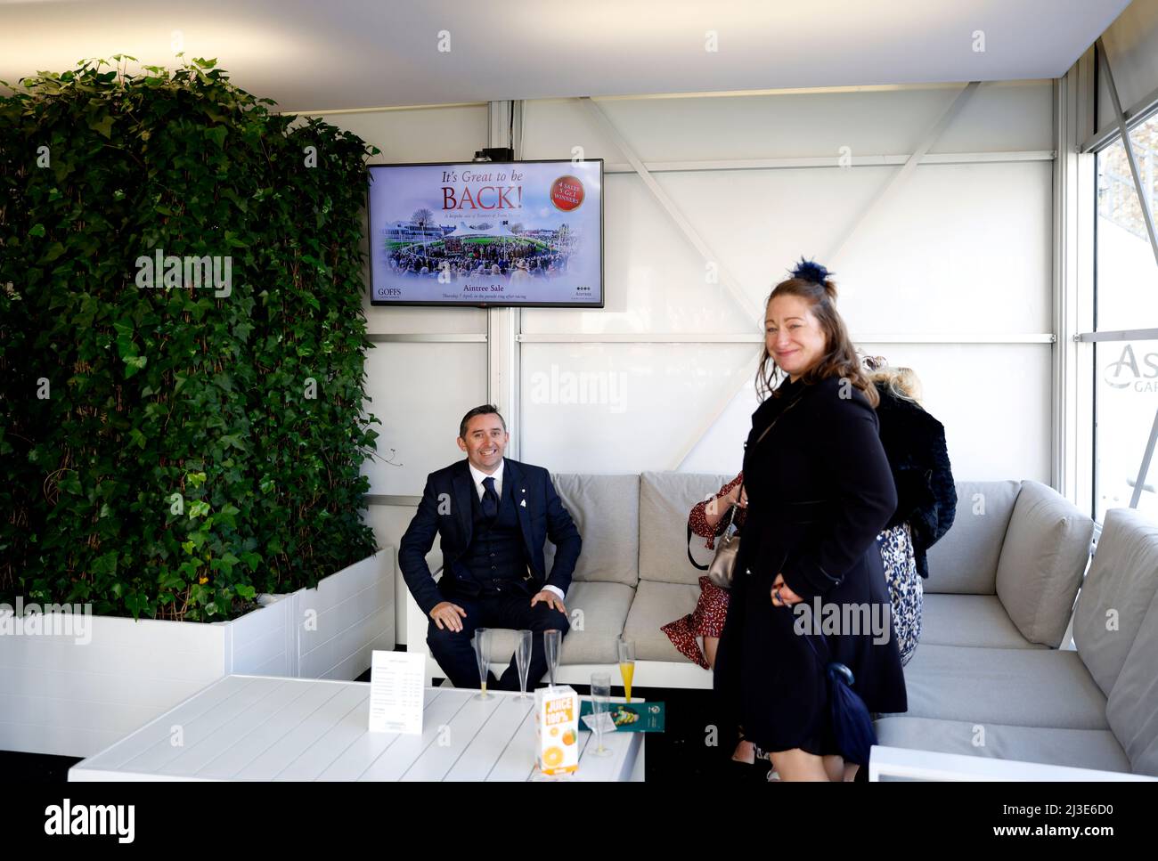 Racegoers in the Moet & Chandon champagne bar at Aintree Racecourse ...