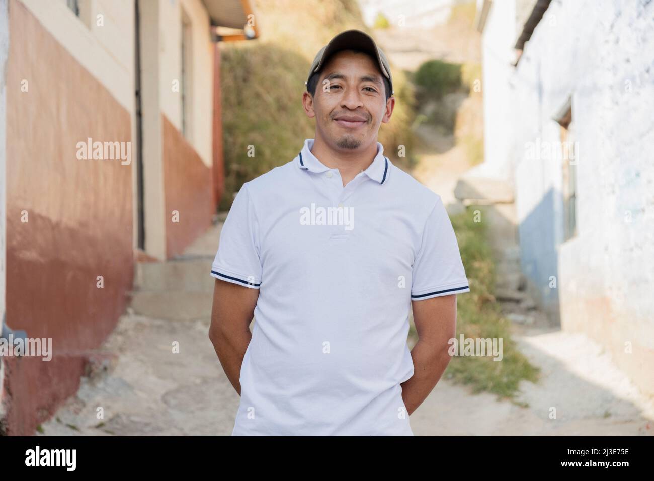 Latin man smiling outside his house in rural area - Hispanic man proud of his roots Stock Photo