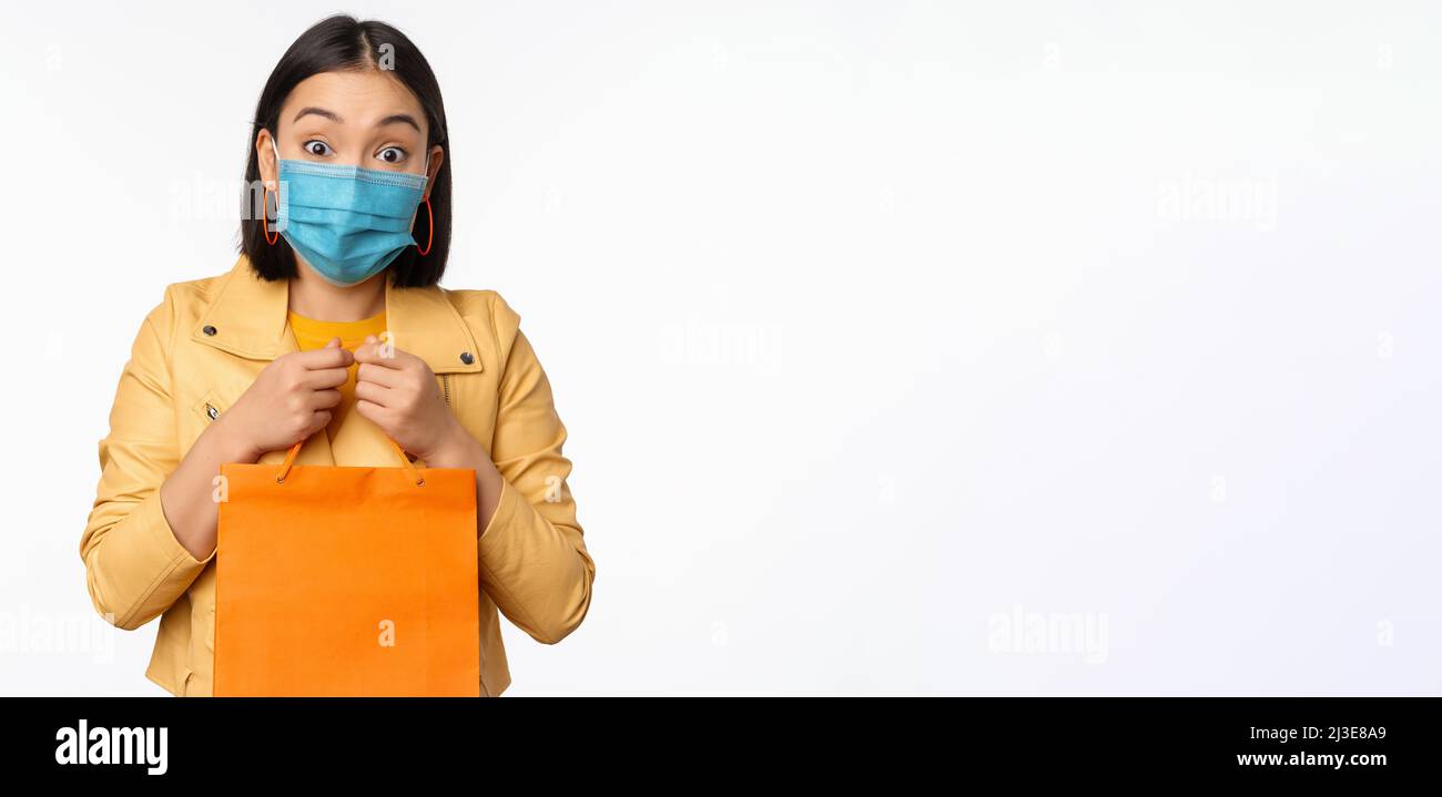 Covid19 and shop concept. Young asian stylish woman, wearing medical