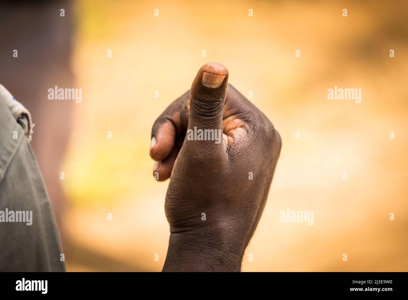 Sign of approval. All is well. Thumbs up. Dark-skinned person. Horizontal. Color. Stock Photo