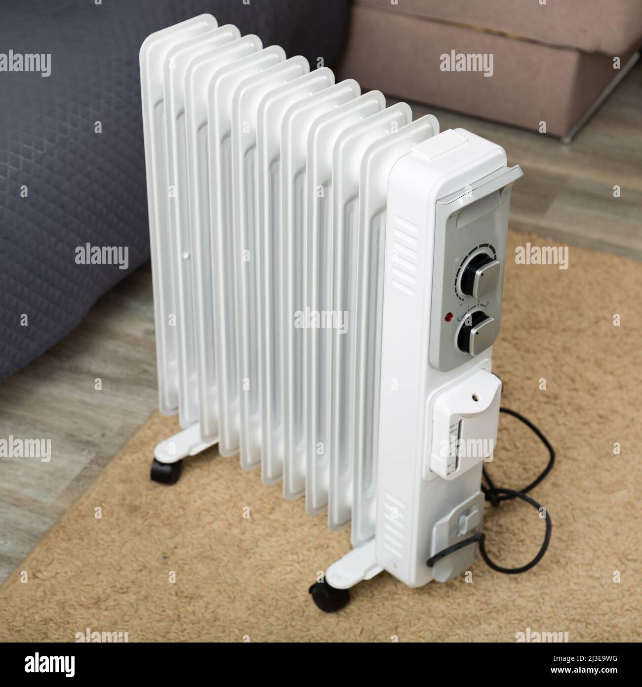 Electric oil heater on floor in room Stock Photo Alamy