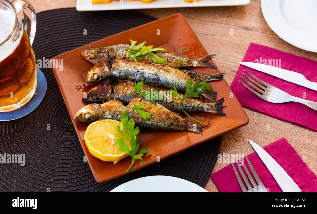 Fried sardines with lemon and parsley Stock Photo Alamy