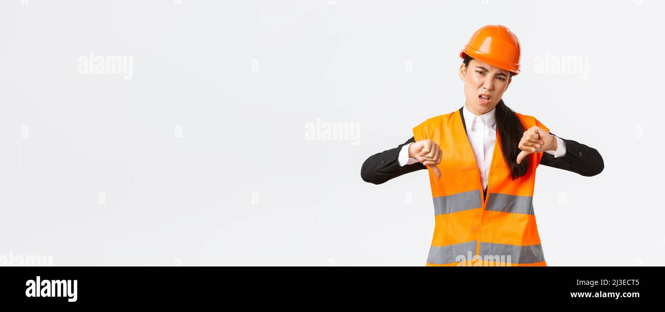 Disappointed and upset asian female chief engineer inspect bad work ...