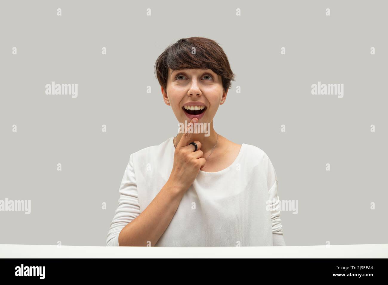 Silly and funny expression of a woman who has a great idea or solution to a problem. Funny and witty representation of the concept of imagination and Stock Photo