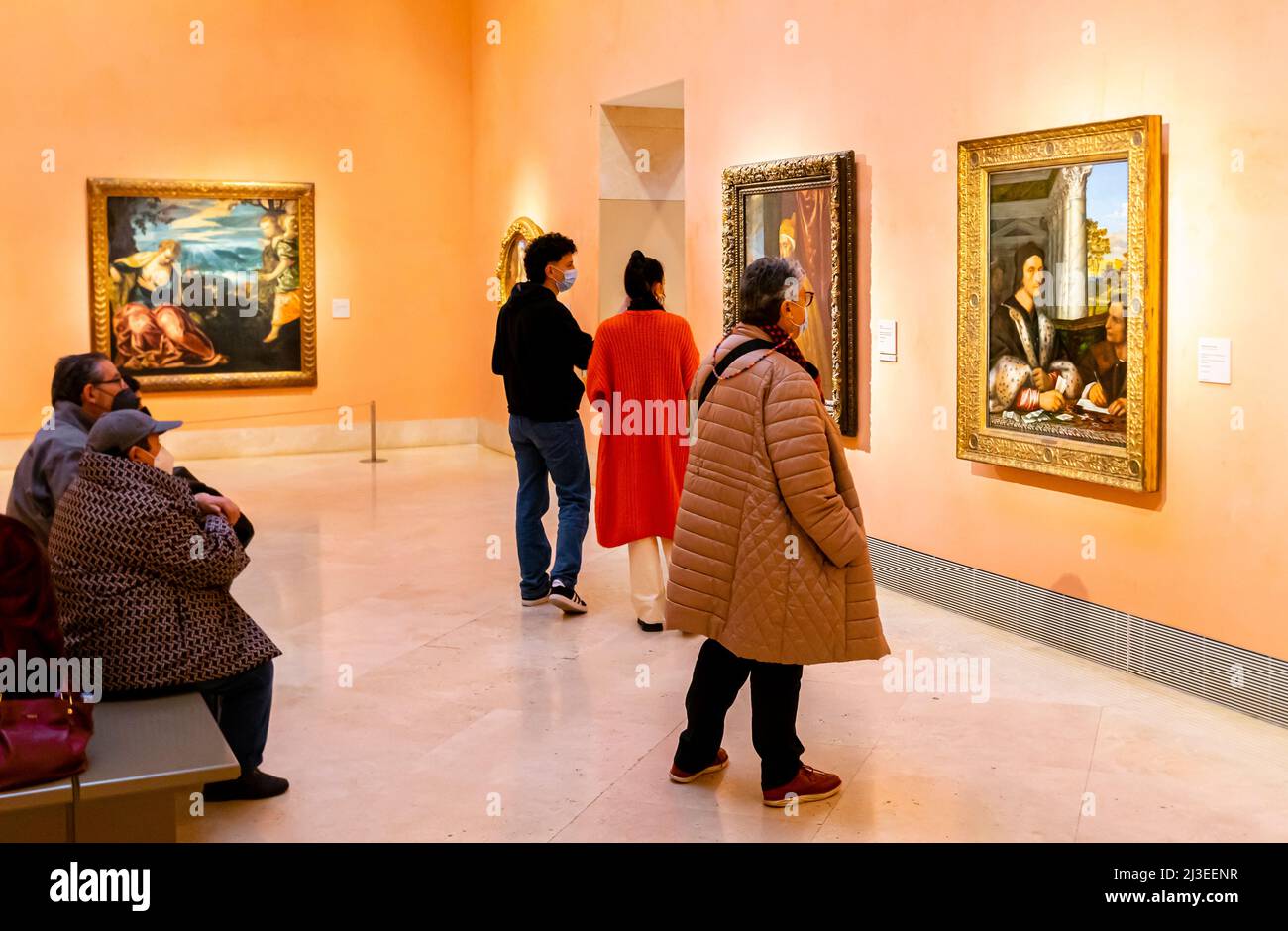 Visitors looking at classic Renaissance paintings in the Thyssen-Bornemisza National Museum Stock Photo