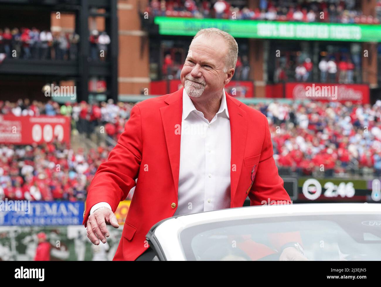 Former St. Louis Cardinals slugger Mark McGwire waves to fans as he is  driven around the track before a game against the Pittsburgh Pirates on  Opening Day in St. Louis on Thursday