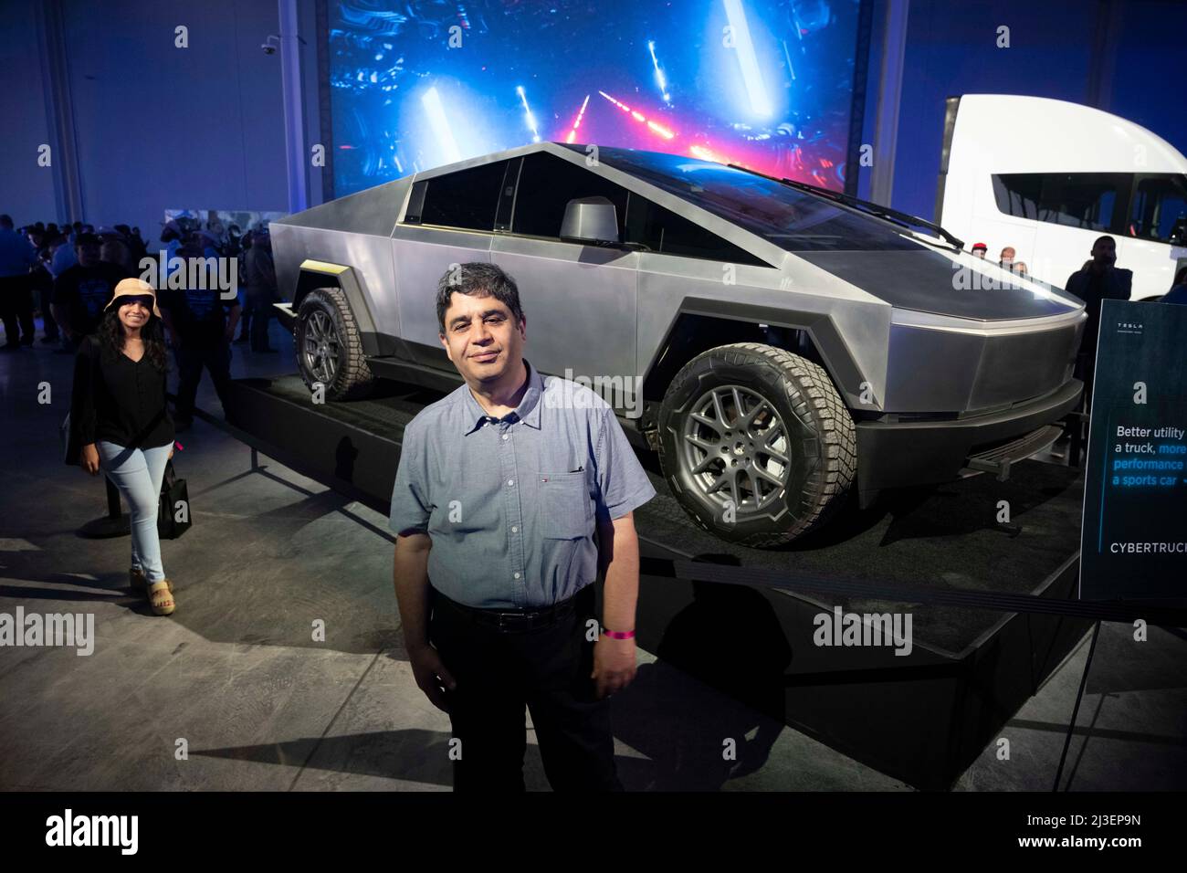Austin Texas USA, April 7 2022 A man poses with the new Tesla