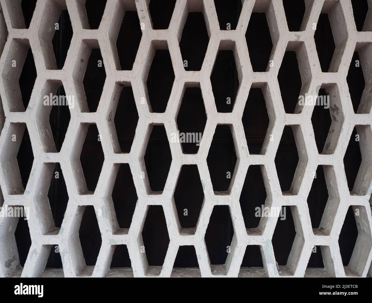 Cement plaster wall with decorative retro hole pattern Stock Photo
