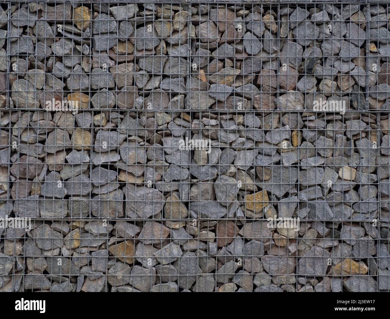 Decorative fence of bulk stone in the grid Stock Photo Alamy