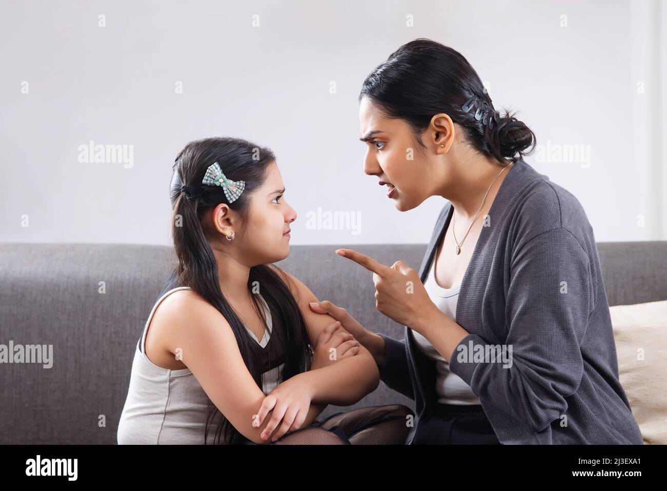 An angry mother ruling her daughter by pointing a finger Stock Photo - Alamy