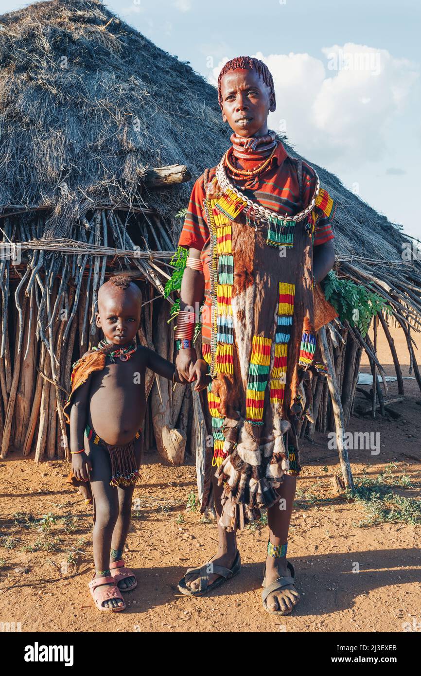 Turmi, Omo River Valley, Ethiopia - May 10, 2019: Portrait of a beautiful woman with children in Hamar village. Hamars are the original tribe in south Stock Photo