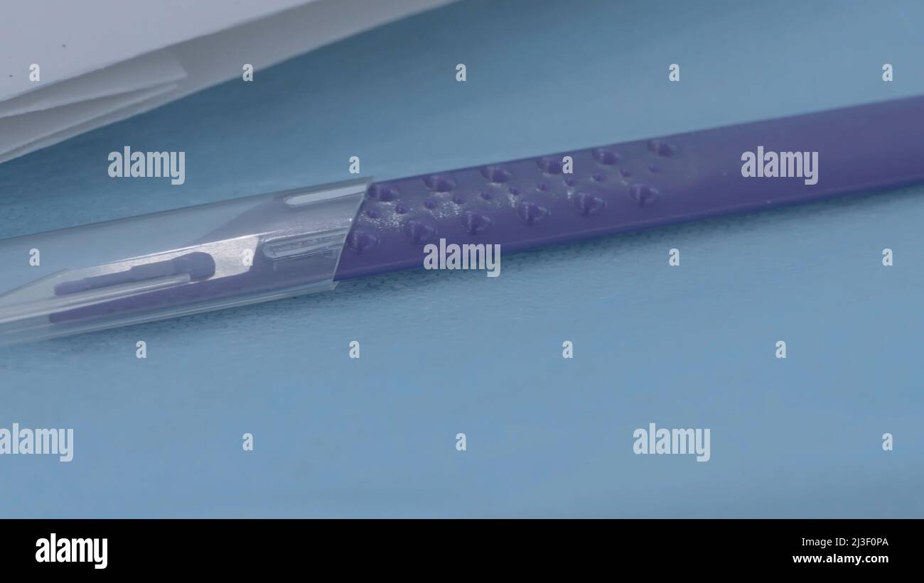 Close-up of medical scalpel. Action. One of models of scalpels for ...