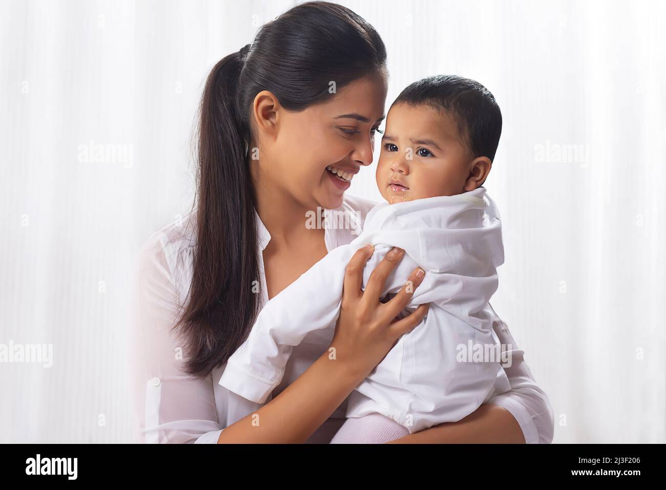 Indian woman carrying baby hi-res stock photography and images - Alamy