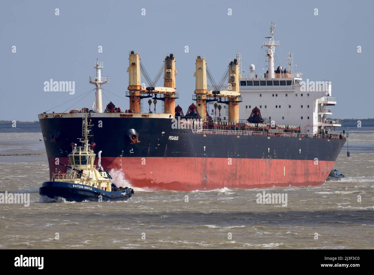 Gravesend UK Strong winds whip up the waves on the River Thames as ships and boats ply their trade on the Liquid Highway. Stock Photo
