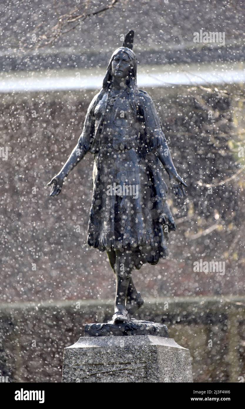 01/04/2022 Gravesend UK Snow falling on the first day of April around the memorial to Princess Pocahontas in the grounds of St George’s Church in Grav Stock Photo