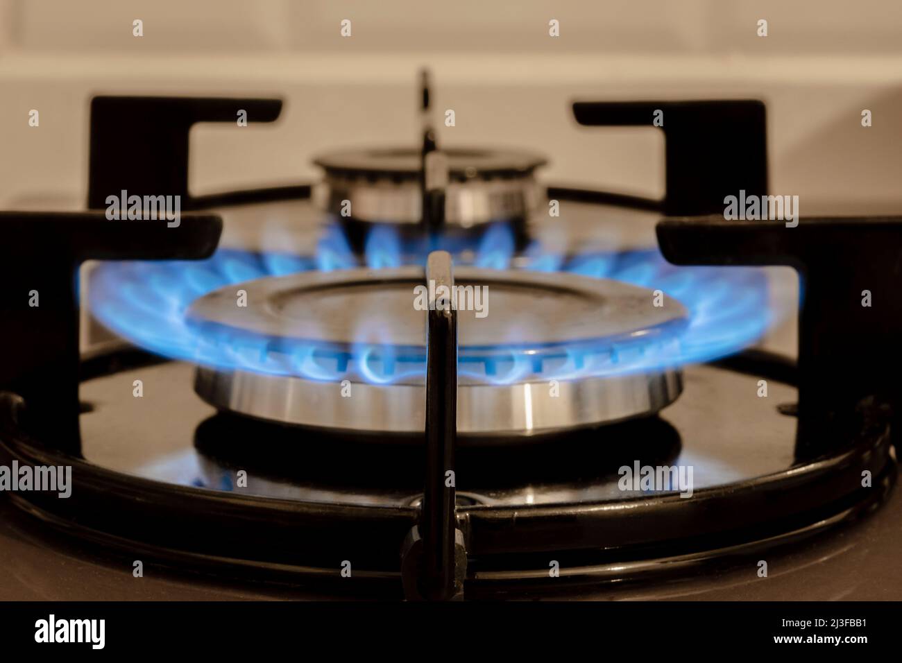 Flame On  Stove burner, close-Up Of Gas Stove Burners. Selective focus burner.  Selectice Focus Front view. Stock Photo