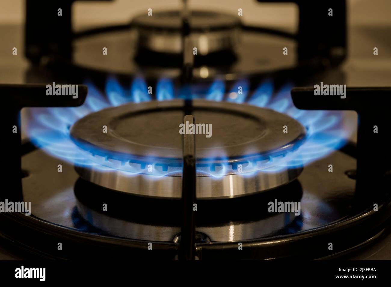 Flame On  Stove burner, close-Up Of Gas Stove Burners. Selective focus burner.  Selectice Focus Front view. Stock Photo
